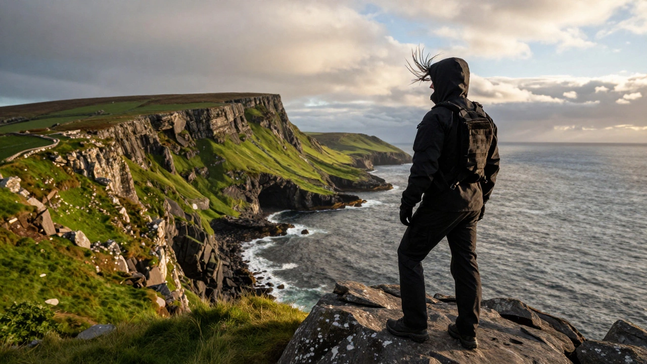 Hiker in SWAT jacket on windy Irish cliff overlooking ocean